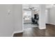Hallway view into a modern home office with a large window, gaming setup, and a ceiling fan at 59 N Clearbrook Ct, Angier, NC 27501
