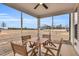 Enclosed patio featuring a wooden dining set to provide ample space for outdoor dining and relaxation at 59 N Clearbrook Ct, Angier, NC 27501