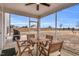 The enclosed patio features a ceiling fan and a wooden dining set perfect for outdoor relaxation at 59 N Clearbrook Ct, Angier, NC 27501
