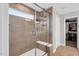 Modern tiled shower with glass doors, a built-in bench, and shelving for bath essentials at 59 N Clearbrook Ct, Angier, NC 27501