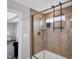 Modern tiled shower with glass doors, a built-in bench, and shelving for bath essentials at 59 N Clearbrook Ct, Angier, NC 27501