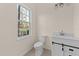 Bright bathroom featuring a large window, modern fixtures, and a sliding barn door on the vanity at 612 Lakeview Dr, Raleigh, NC 27603