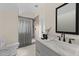Elegant bathroom featuring a gray vanity with a white countertop and modern fixtures plus a walk-in shower at 612 Lakeview Dr, Raleigh, NC 27603