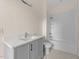 Bright bathroom featuring a gray vanity, undermount sink and a shower with white subway tile at 612 Lakeview Dr, Raleigh, NC 27603