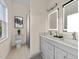 A bright bathroom with a double vanity, neutral tile, and shower/tub combo at 612 Lakeview Dr, Raleigh, NC 27603