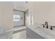 Well lit bathroom features white marble countertop and a glass shower with tile accents at 612 Lakeview Dr, Raleigh, NC 27603