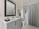 Modern bathroom with gray vanity, quartz countertop, and shower/tub with white subway tiles at 612 Lakeview Dr, Raleigh, NC 27603
