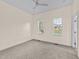 An empty bedroom with neutral tones, plush carpet, and bright natural light at 612 Lakeview Dr, Raleigh, NC 27603