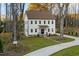 Charming three-story home boasting a manicured lawn, stone pathway, and elegant white siding at 612 Lakeview Dr, Raleigh, NC 27603
