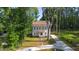 Charming two-story home with a well-manicured lawn and a long driveway surrounded by lush greenery at 612 Lakeview Dr, Raleigh, NC 27603