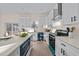 Modern kitchen with stainless steel appliances, granite countertops and an island, ideal for meal preparation at 612 Lakeview Dr, Raleigh, NC 27603