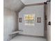 Contemporary shower with gray tiling, seating, and a sunlit window view at 612 Lakeview Dr, Raleigh, NC 27603