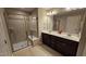 Bathroom featuring a double sink vanity, glass enclosed shower, and tiled walls at 621 Rockcastle Dr, Cary, NC 27519