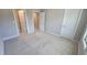 Bright bedroom featuring neutral walls, plush carpet, and two doors at 621 Rockcastle Dr, Cary, NC 27519