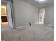 Spacious bedroom featuring neutral carpet, base trim, and an ensuite bathroom at 621 Rockcastle Dr, Cary, NC 27519