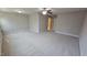 Large carpeted bedroom with ceiling fan and two entry doors at 621 Rockcastle Dr, Cary, NC 27519