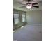 Spacious carpeted bedroom with ceiling fan and two windows at 621 Rockcastle Dr, Cary, NC 27519