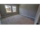 Cozy bedroom with a large double window for ample natural light and neutral carpeting at 621 Rockcastle Dr, Cary, NC 27519