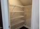 Walk-in closet featuring tiered metal shelves and ample storage capacity at 621 Rockcastle Dr, Cary, NC 27519