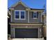 Charming two-story home featuring a brick facade, a two-car garage, and neutral-colored siding at 621 Rockcastle Dr, Cary, NC 27519