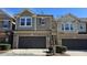 Street view of gray home featuring two-car garage, manicured shrubbery and tidy sidewalk at 621 Rockcastle Dr, Cary, NC 27519