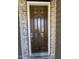 Modern brown front door, brick surround, and neutral siding on a home exterior at 621 Rockcastle Dr, Cary, NC 27519