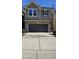 Two-story home with gray siding, brick facade, two-car garage, and concrete driveway at 621 Rockcastle Dr, Cary, NC 27519