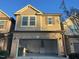 Well lit garage with white walls and dark door in a two-story home at 621 Rockcastle Dr, Cary, NC 27519