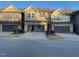 Townhome with a spacious two-car garage and neutral-colored exterior at 621 Rockcastle Dr, Cary, NC 27519