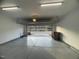 Open garage with epoxy-coated floor and an open garage door at 621 Rockcastle Dr, Cary, NC 27519