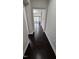 Inviting hallway featuring dark wood floors leading into a sunlit living room at 621 Rockcastle Dr, Cary, NC 27519