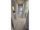 Carpeted hallway with access to the bathroom, laundry, and bedroom at 621 Rockcastle Dr, Cary, NC 27519