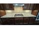 Close-up on the kitchen's granite countertop, gas cooktop, and tile backsplash at 621 Rockcastle Dr, Cary, NC 27519