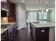 Open kitchen with granite countertops, stainless steel appliances, and dark wood cabinets at 621 Rockcastle Dr, Cary, NC 27519