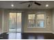 Bright living room features hardwood floors, a ceiling fan, and natural light from the sliding glass door and windows at 621 Rockcastle Dr, Cary, NC 27519