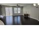 Bright living room features hardwood floors, a ceiling fan, and natural light from the sliding glass door and windows at 621 Rockcastle Dr, Cary, NC 27519