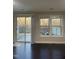 Bright living room features hardwood floors, a ceiling fan, and natural light from the sliding glass door and windows at 621 Rockcastle Dr, Cary, NC 27519