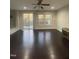 Bright living room features hardwood floors, a ceiling fan, and natural light from the sliding glass door and windows at 621 Rockcastle Dr, Cary, NC 27519