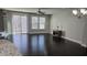 Open concept living room featuring dark wood floors, a ceiling fan, and natural lighting at 621 Rockcastle Dr, Cary, NC 27519