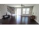 Spacious living room featuring dark wood floors, lots of light, and a ceiling fan at 621 Rockcastle Dr, Cary, NC 27519