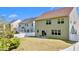 Spacious backyard, featuring a well-maintained lawn, small patio and a white fence, providing privacy at 69 Florence Dr, Clayton, NC 27527