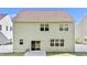 View of the rear exterior with a sliding glass door leading to a small patio and a well-kept lawn at 69 Florence Dr, Clayton, NC 27527