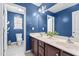 Well lit bathroom with double vanity, framed mirror, and blue accent wall at 69 Florence Dr, Clayton, NC 27527