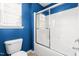Bathroom with a toilet, glass shower door, and a window at 69 Florence Dr, Clayton, NC 27527