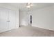 Bedroom featuring neutral carpet, white walls, and double door closet at 69 Florence Dr, Clayton, NC 27527