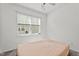 Cozy bedroom with a neutral color palette, a ceiling fan, and a bright window at 69 Florence Dr, Clayton, NC 27527