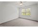 Simple bedroom featuring carpet flooring, white walls, and a window at 69 Florence Dr, Clayton, NC 27527