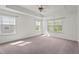 Spacious bedroom with carpet flooring, ceiling fan, and multiple windows for natural light at 69 Florence Dr, Clayton, NC 27527