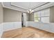 Dining room featuring hardwood floors, modern lighting, and a large bright window at 69 Florence Dr, Clayton, NC 27527