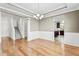 Open dining area with hardwood floors, wainscoting, and direct access to the kitchen and staircase at 69 Florence Dr, Clayton, NC 27527